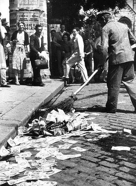 Discarded Banknotes being swept up in the streets of Hungary during 1946 inflation crisis